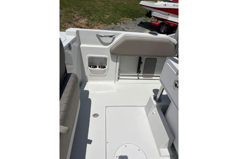 Slide: The Image of Interior view of 2026 Crownline 210 CC Finseeker boat, featuring seating and storage compartments. - 4
