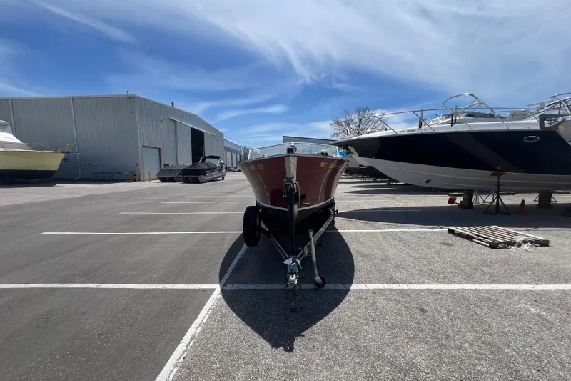Slide: The Image of 1997 Grand Craft 24 Luxury Sport boat on trailer in marina parking lot. - 2