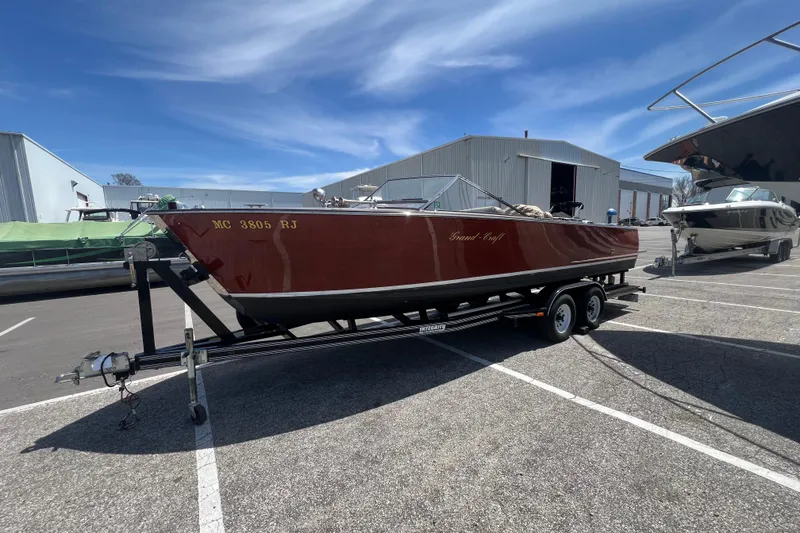 Slide: The Image of 1997 Grand Craft 24 Luxury Sport boat on trailer in marina parking lot. - 3