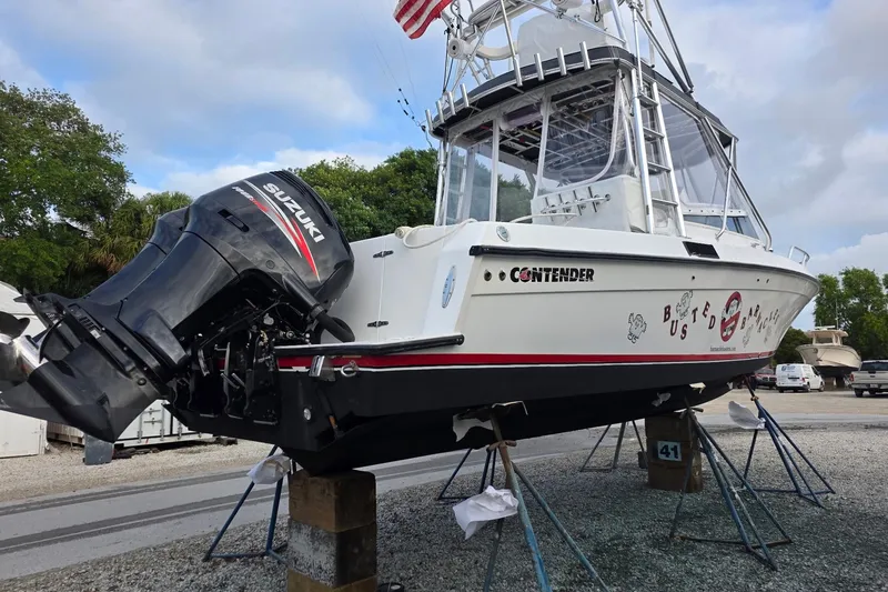 The Image of 2008 Contender 35 Express Side Console boat with Suzuki outboard engine on dry dock. - 1