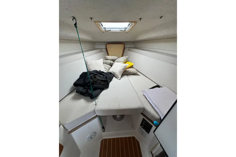 Slide: The Image of Cozy cabin interior of 2008 Contender 35 Express Side Console with cushions and skylight. - 13