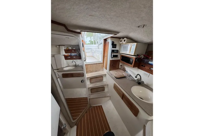 Slide: The Image of Interior of 2008 Contender 35 Express Side Console with kitchenette and sink. - 15