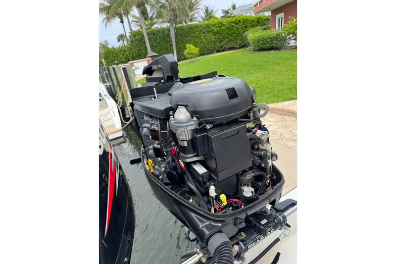 Slide: The Image of Outboard motor of a 2008 Contender 35 Express Side Console boat docked by water. - 19