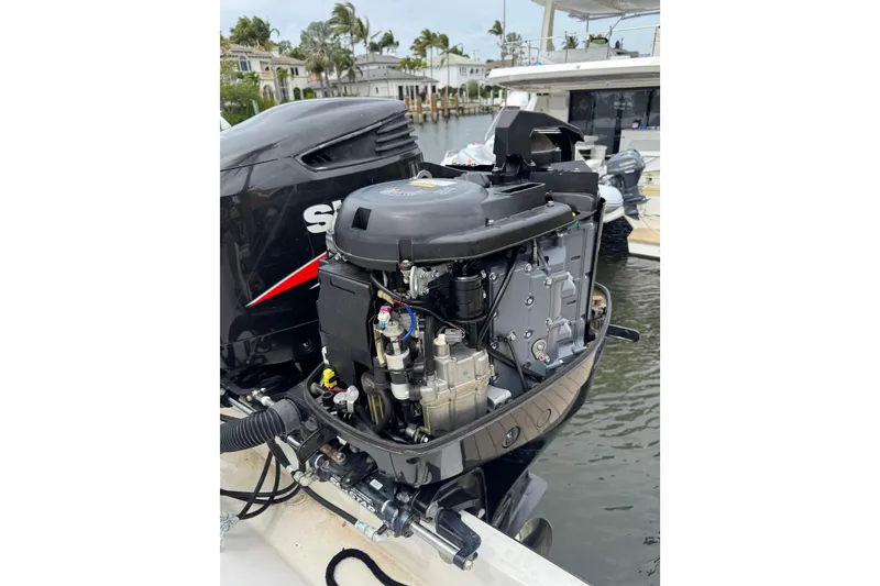 Slide: The Image of Outboard motor of a 2008 Contender 35 Express Side Console boat at a marina. - 20