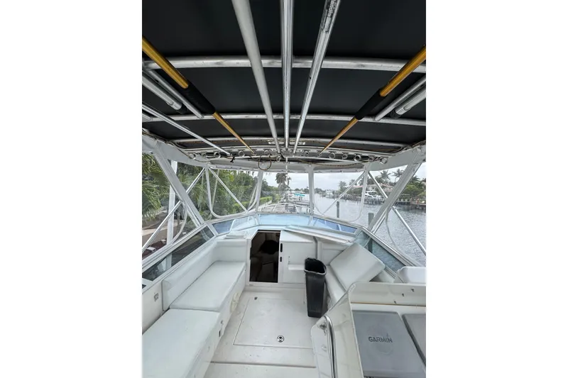 Slide: The Image of 2008 Contender 35 Express Side Console boat interior with seating and waterway view. - 22