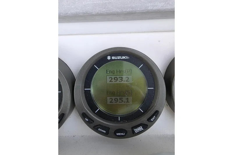 Slide: The Image of Suzuki engine hours display on 2008 Contender 35 Express Side Console, showing 293.2 and 295.1 hours. - 3