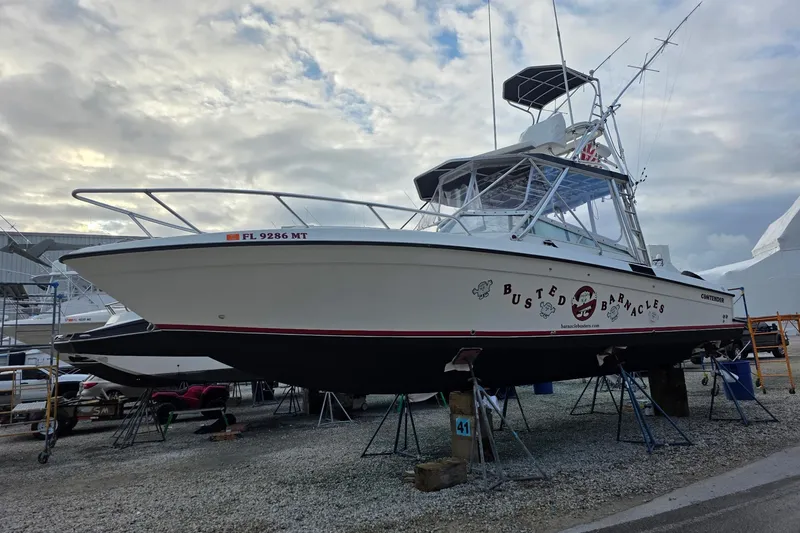 Slide: The Image of 2008 Contender 35 Express Side Console boat on stands, overcast sky background. - 5