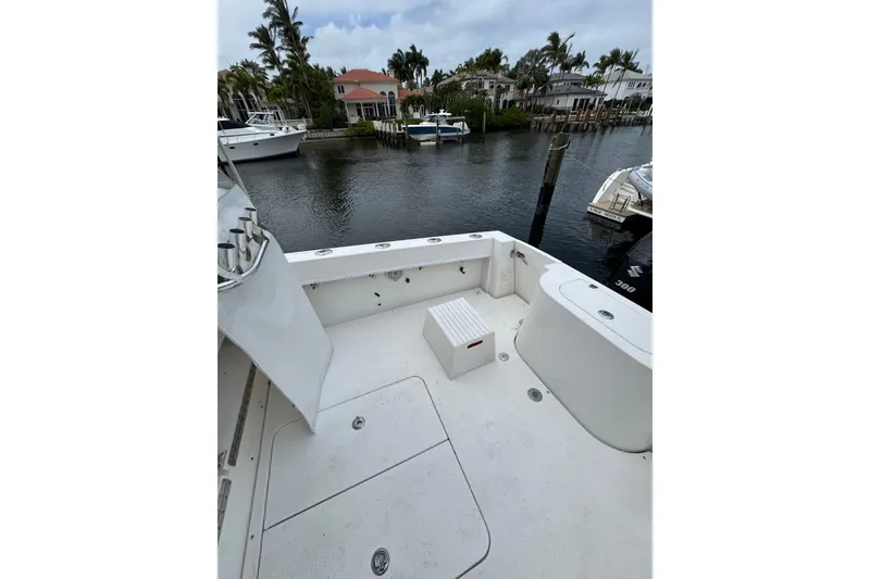 Slide: The Image of 2008 Contender 35 Express Side Console boat docked by waterfront homes. - 7