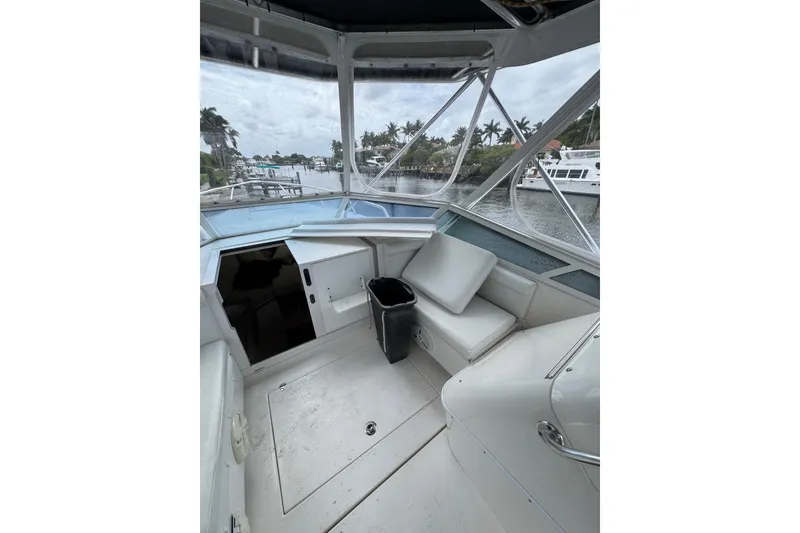 Slide: The Image of 2008 Contender 35 Express Side Console boat interior with seating and water view. - 8