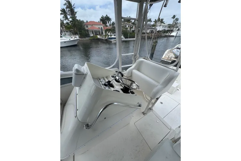 Slide: The Image of 2008 Contender 35 Express Side Console boat interior with steering wheel and seating. - 9