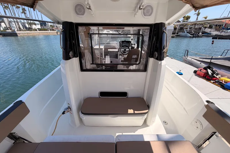 Slide: The Image of 2017 Jeanneau Merry Fisher 855 Marlin boat interior with seating and waterfront view. - 11