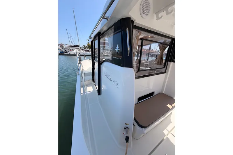 Slide: The Image of 2017 Jeanneau Merry Fisher 855 Marlin docked, showcasing sleek design and spacious interior. - 19