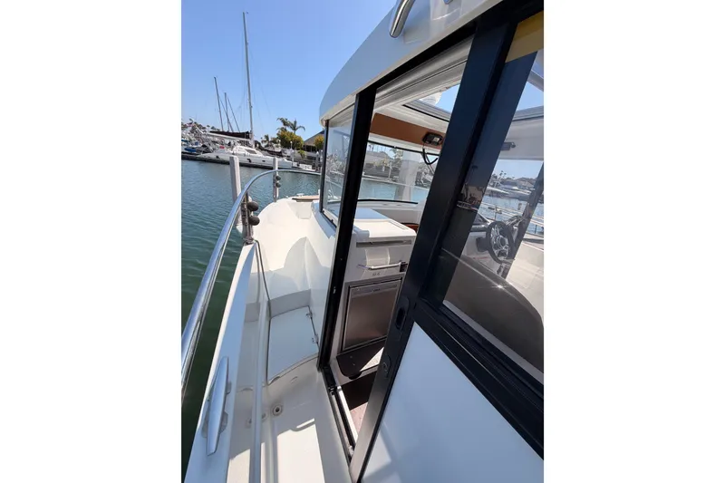 Slide: The Image of 2017 Jeanneau Merry Fisher 855 Marlin boat docked at marina, side view. - 20
