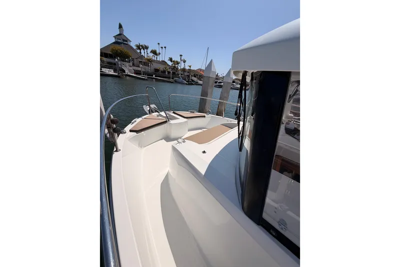 Slide: The Image of 2017 Jeanneau Merry Fisher 855 Marlin boat docked in a marina under clear skies. - 22