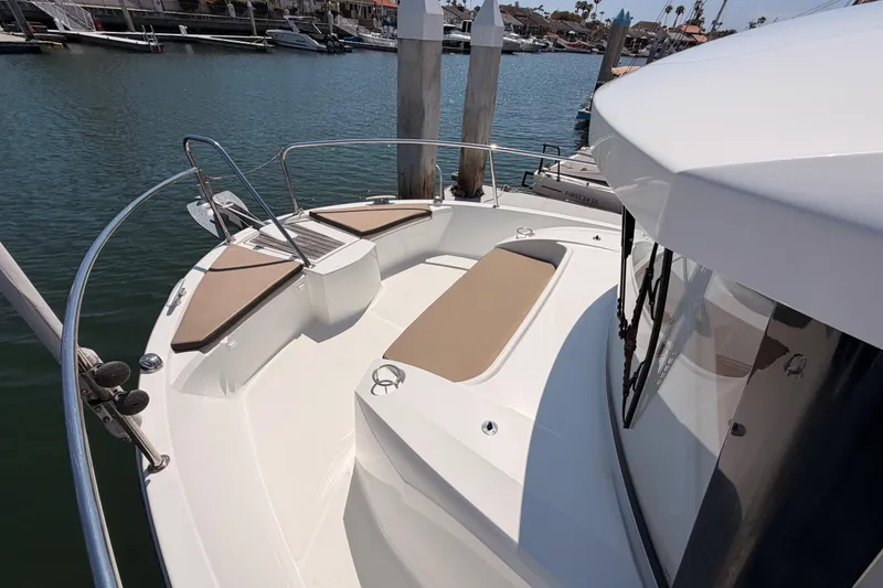 Slide: The Image of 2017 Jeanneau Merry Fisher 855 Marlin boat deck with seating, docked in marina. - 23