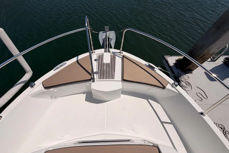Slide: The Image of Bow view of 2017 Jeanneau Merry Fisher 855 Marlin, featuring anchor and seating. - 24