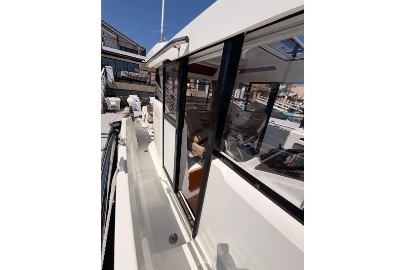 Slide: The Image of 2017 Jeanneau Merry Fisher 855 Marlin boat exterior with side walkway and cabin view. - 28