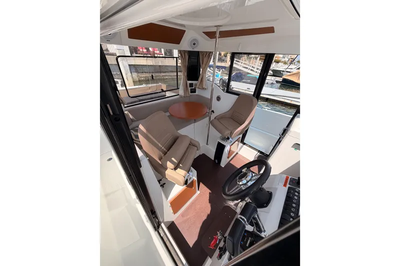 Slide: The Image of Interior of 2017 Jeanneau Merry Fisher 855 Marlin with seating and steering wheel. - 29