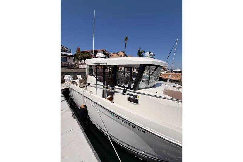 Slide: The Image of 2017 Jeanneau Merry Fisher 855 Marlin docked at marina under clear blue sky. - 3