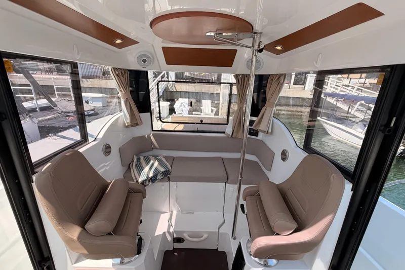 Slide: The Image of Interior of 2017 Jeanneau Merry Fisher 855 Marlin, featuring comfortable seating and panoramic windows. - 31
