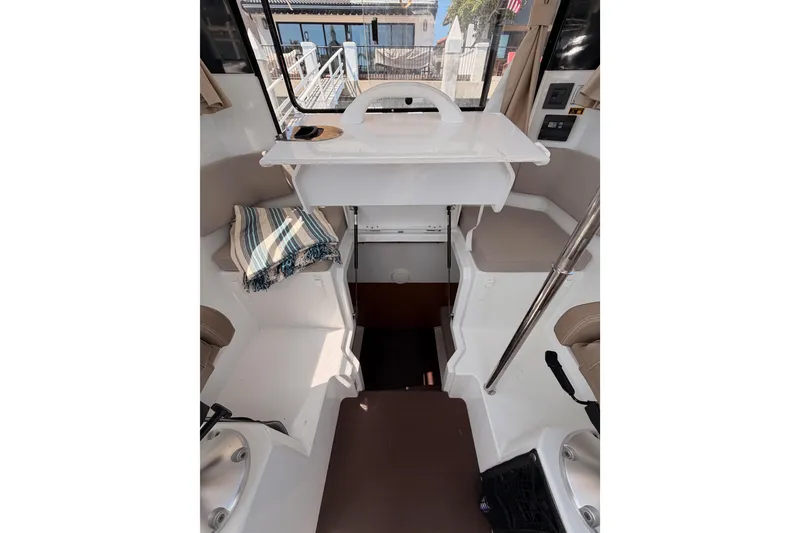 Slide: The Image of Interior of 2017 Jeanneau Merry Fisher 855 Marlin boat, featuring seating and helm area. - 34