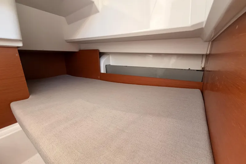 Slide: The Image of Interior cabin of 2017 Jeanneau Merry Fisher 855 Marlin with wooden accents and cushioned berth. - 37
