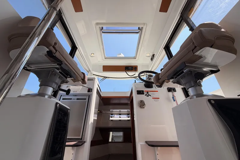 Slide: The Image of Interior view of 2017 Jeanneau Merry Fisher 855 Marlin boat, featuring helm and seating area. - 41