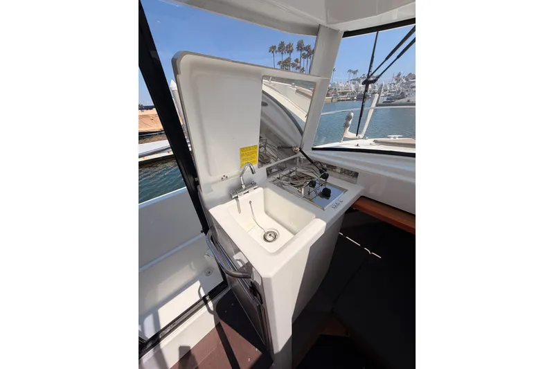 Slide: The Image of Interior view of 2017 Jeanneau Merry Fisher 855 Marlin boat kitchen area with sink and stove. - 44