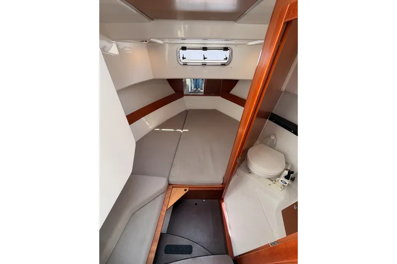 Slide: The Image of 2017 Jeanneau Merry Fisher 855 Marlin cabin interior with bed and compact toilet. - 54