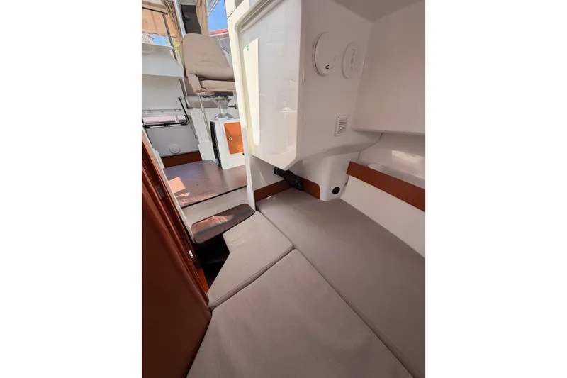 Slide: The Image of Interior view of 2017 Jeanneau Merry Fisher 855 Marlin boat, showcasing seating and cabin area. - 56