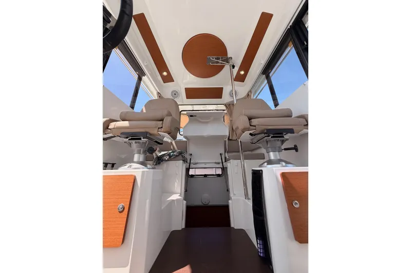 Slide: The Image of Interior of 2017 Jeanneau Merry Fisher 855 Marlin with modern seating and wood accents. - 58