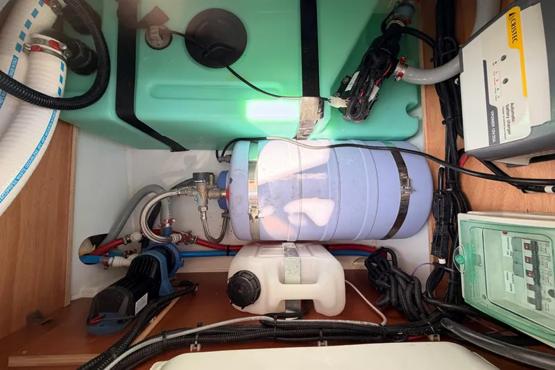 Slide: The Image of Engine compartment of 2017 Jeanneau Merry Fisher 855 Marlin with various components and wiring. - 59