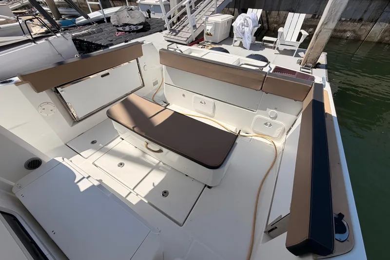 Slide: The Image of 2017 Jeanneau Merry Fisher 855 Marlin boat deck with seating and storage. - 60