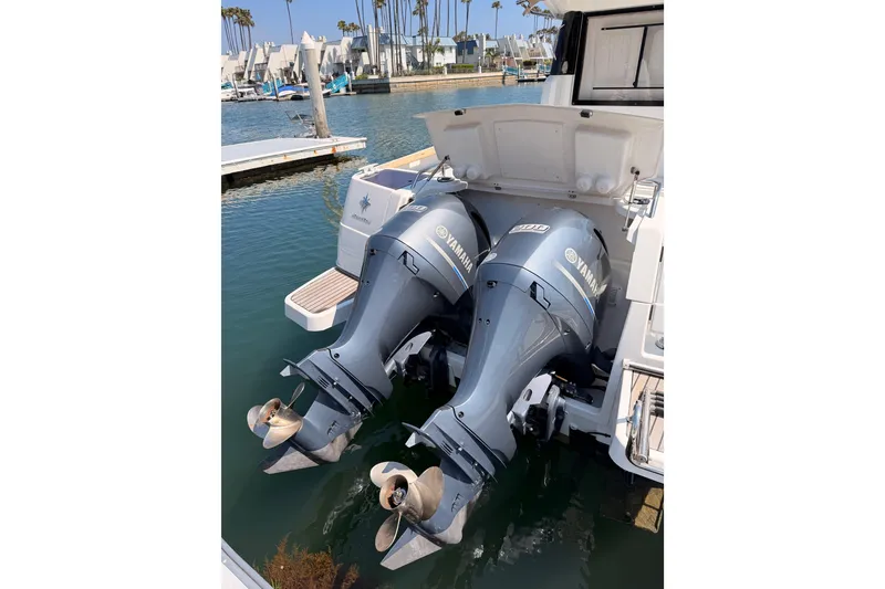 Slide: The Image of Twin Yamaha outboard engines on a 2017 Jeanneau Merry Fisher 855 Marlin boat docked in a marina. - 63