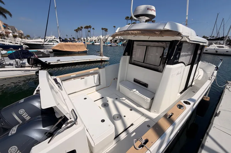Slide: The Image of 2017 Jeanneau Merry Fisher 855 Marlin docked in a marina, featuring Yamaha engines. - 64