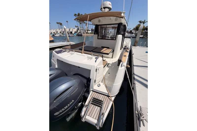 Slide: The Image of 2017 Jeanneau Merry Fisher 855 Marlin docked with twin Yamaha engines. - 8