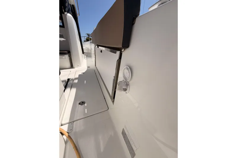 Slide: The Image of 2017 Jeanneau Merry Fisher 855 Marlin deck view, showcasing sleek design and storage features. - 9