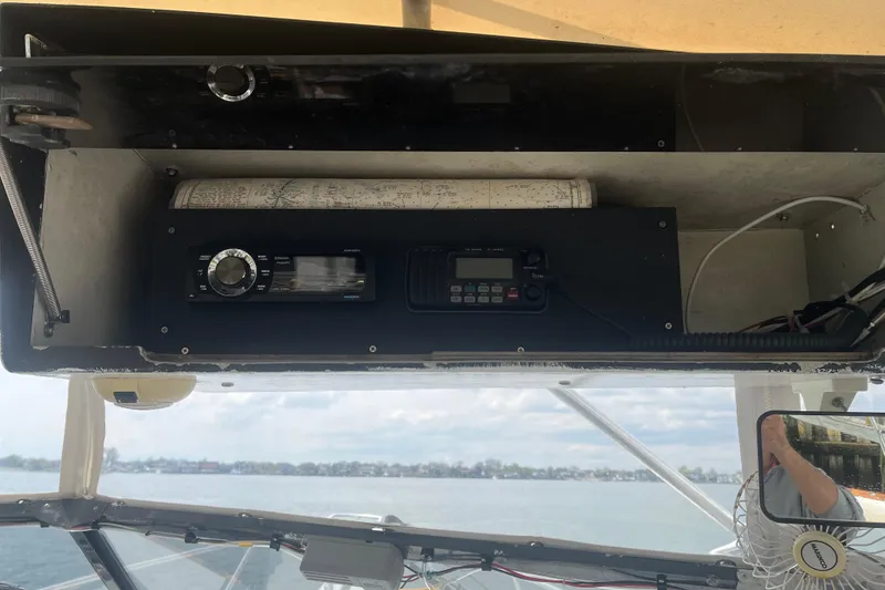 Slide: The Image of 1989 Blackfin 31 Combi boat interior with kitchenette, sink, and striped seating. - 11
