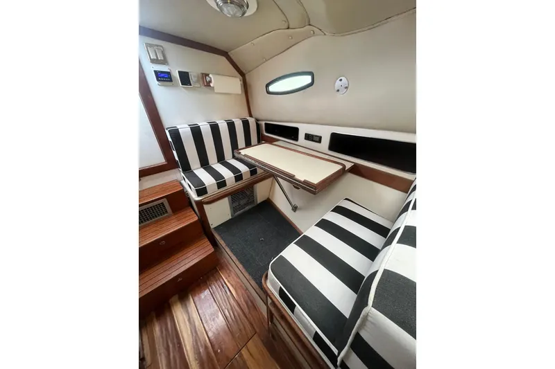 Slide: The Image of 1989 Blackfin 31 Combi interior with control panel and wooden steps. - 12