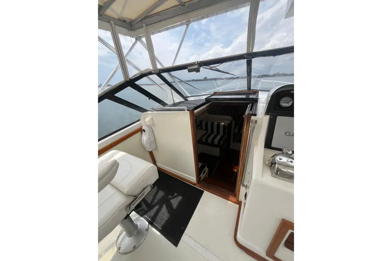 Slide: The Image of 1989 Blackfin 31 Combi boat docked at marina under cloudy sky. - 4