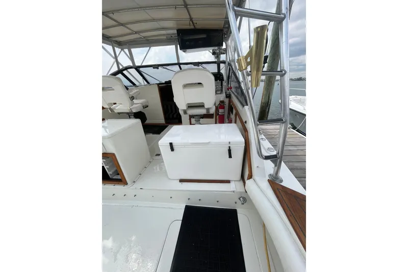 Slide: The Image of 1989 Blackfin 31 Combi boat interior with helm, seating, and open cabin view. - 5