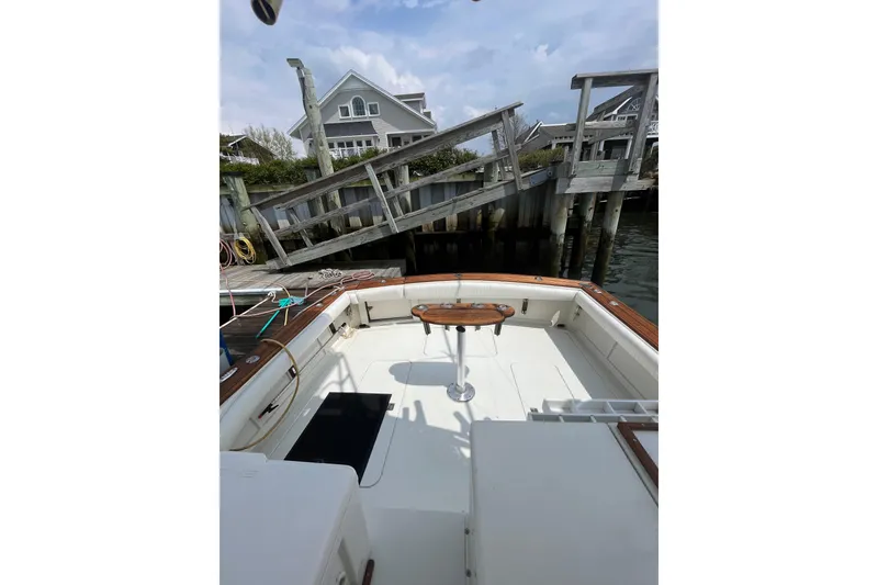 Slide: The Image of 1989 Blackfin 31 Combi boat docked, featuring spacious deck and wooden accents. - 7