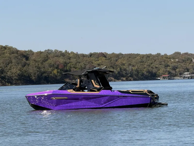 Slide: The Image of Purple 2025 Nautique Super Air Nautique G25 Paragon on a serene lake. - 31