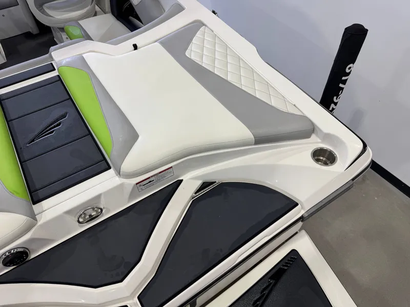 Slide: The Image of Interior of a 2014 Tigé Z1 boat with green and gray upholstery. - 10