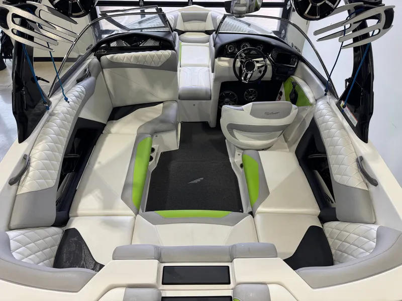 Slide: The Image of Interior of a 2014 Tigé Z1 boat with white and green upholstery. - 12