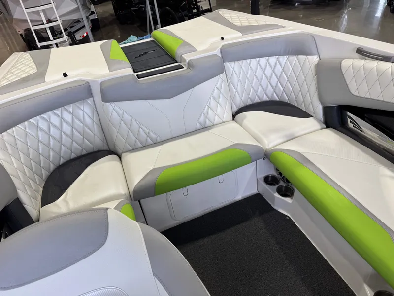 Slide: The Image of Interior of a 2014 Tigé Z1 boat with green and white upholstery. - 15