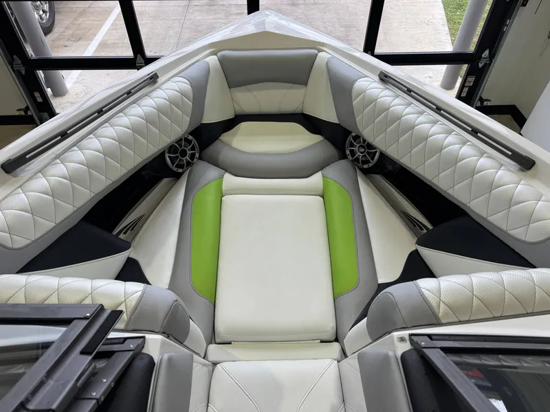 Slide: The Image of Interior of a 2014 Tigé Z1 boat with green accents. - 16