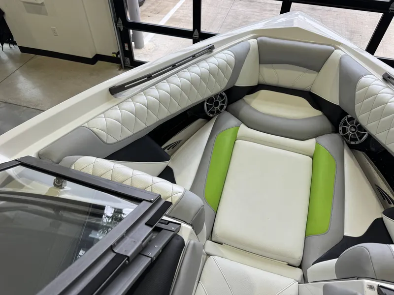 Slide: The Image of Interior of a 2014 Tigé Z1 boat with green accents. - 17