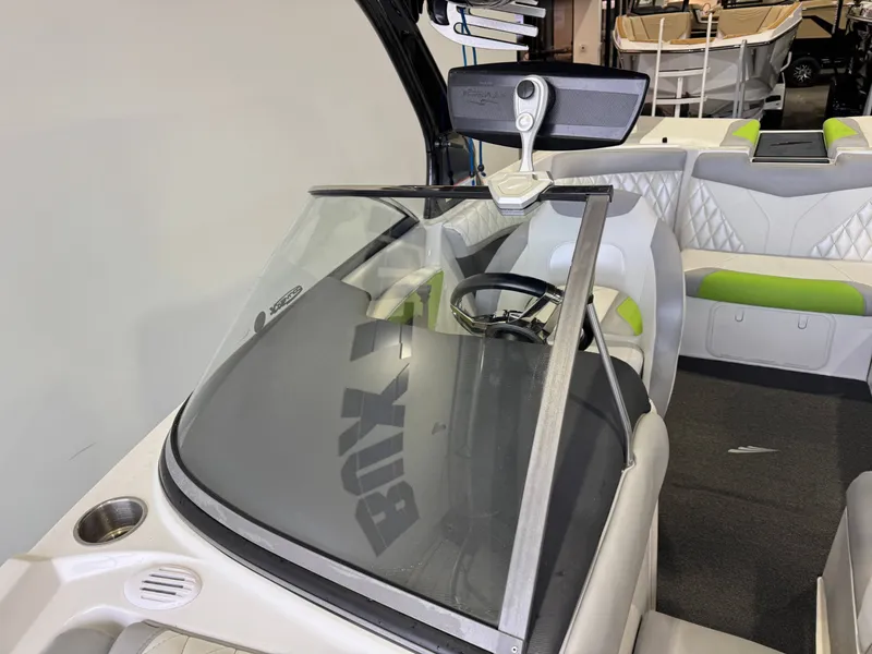 Slide: The Image of Interior view of a 2014 Tigé Z1 boat with steering wheel and seats. - 18