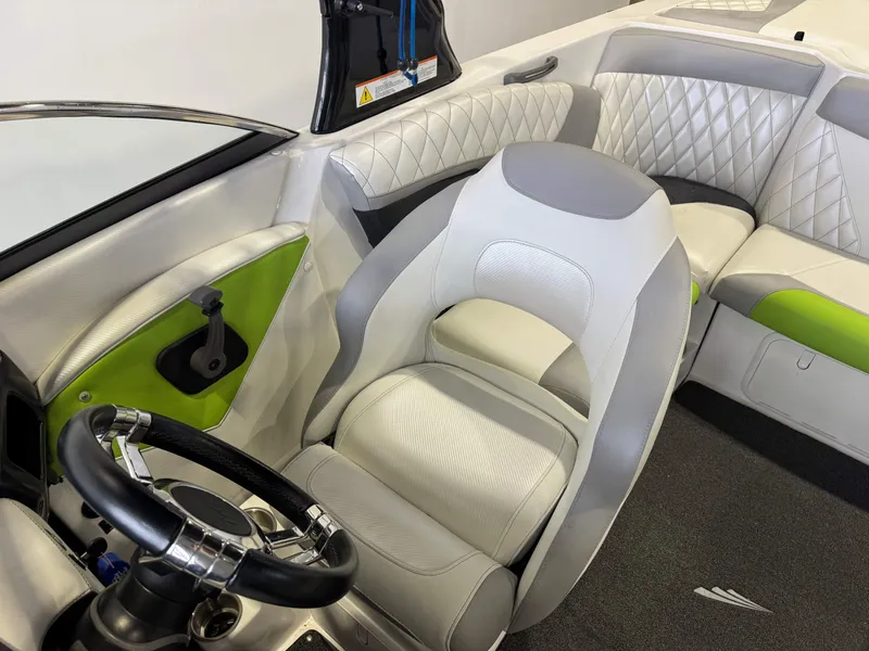 Slide: The Image of Interior of a 2014 Tigé Z1 boat with green accents. - 19